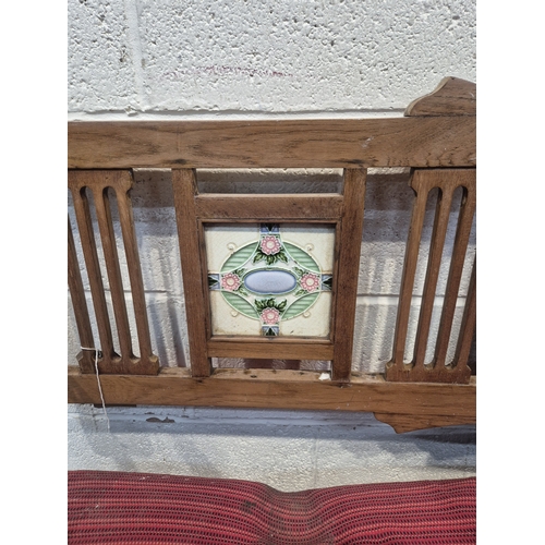 305 - AN ANGLO INDIAN TEAK BENCH, with a railway-style swinging back rest, inlaid with various tiles, rais... 