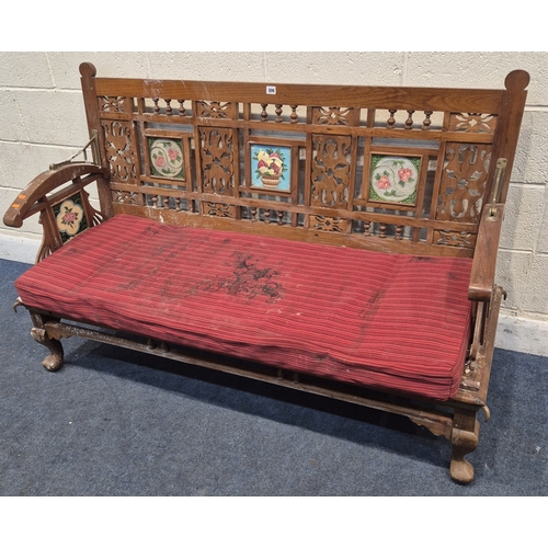 306 - AN ANGLO INDIAN TEAK BENCH, with a railway-style swinging back rest, inlaid with various tiles, rais... 