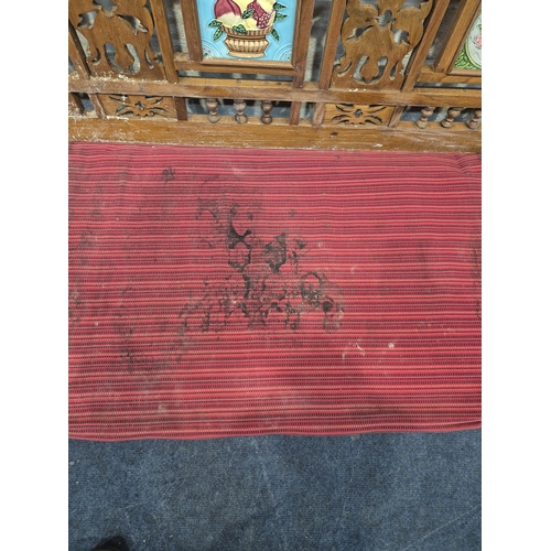 306 - AN ANGLO INDIAN TEAK BENCH, with a railway-style swinging back rest, inlaid with various tiles, rais... 