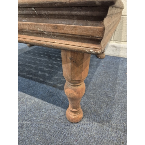 312 - A CARVED INDIAN RECTANGULAR COFFEE TABLE, with a glass insert, raised on block and turned legs, widt... 
