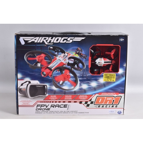 44 - A REMOTE CONTROLLED KYOSHO CHASSIS, TWO BOXED DRONES AND A RADIO CONTROLLER, Kyosho chassis worn wit... 