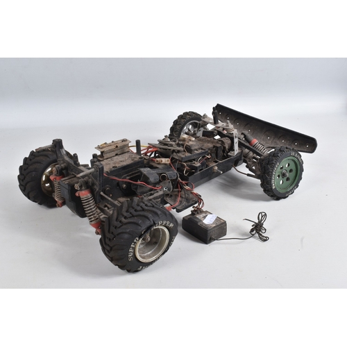 44 - A REMOTE CONTROLLED KYOSHO CHASSIS, TWO BOXED DRONES AND A RADIO CONTROLLER, Kyosho chassis worn wit... 