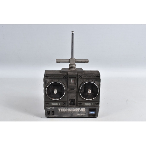 44 - A REMOTE CONTROLLED KYOSHO CHASSIS, TWO BOXED DRONES AND A RADIO CONTROLLER, Kyosho chassis worn wit... 
