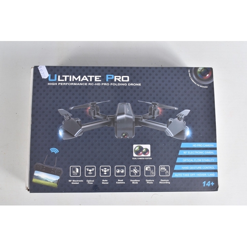44 - A REMOTE CONTROLLED KYOSHO CHASSIS, TWO BOXED DRONES AND A RADIO CONTROLLER, Kyosho chassis worn wit... 