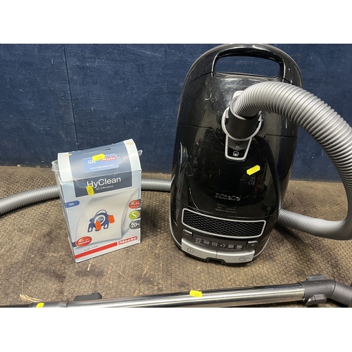 101 - A MIELE S8310 POWER PLUS VACUUM CLEANER (PAT pass and working) and a box with two spare bags