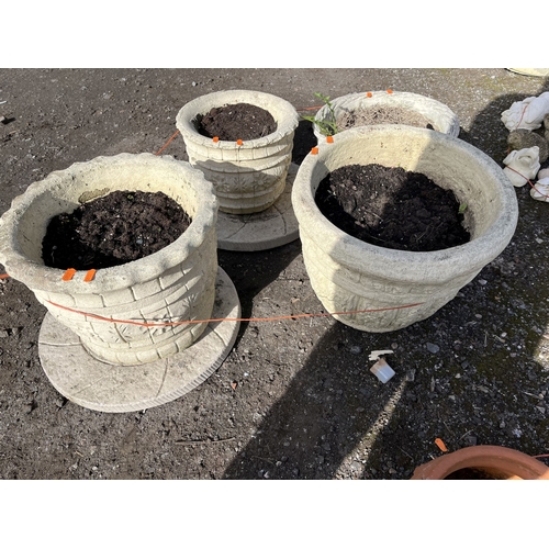 14 - FOUR ROUND CONCRETE PLANTERS AND TWO PLATTERS, including a set of two at 37cm and 31cm respectively ... 