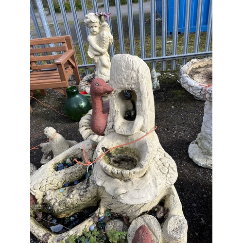 23 - A CONCRETE WATER FEATURE with a cascade of burr effect bowls on a tree stump with a goose at the top... 