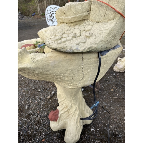 23 - A CONCRETE WATER FEATURE with a cascade of burr effect bowls on a tree stump with a goose at the top... 