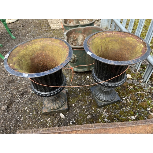 29 - A PAIR OF CAST IRON CAMPAGNA URNS with fluted detailing, height 47cm. Condition Report: rust and pai... 
