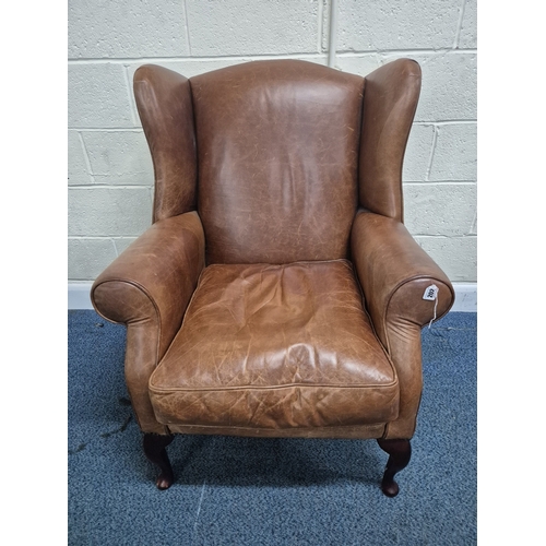 202 - A LAURA ASHLEY TANNED LEATHER WING BACK ARMCHAIR, raised on front cabriole legs, width 81cm x depth ... 