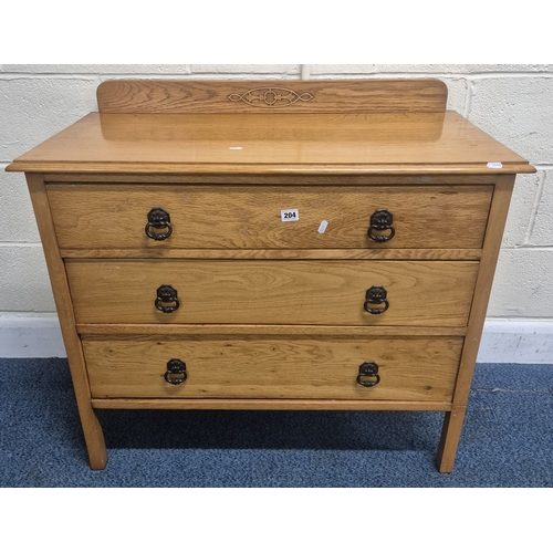 204 - AN OAK LEDGE BACK CHEST OF THREE LONG DRAWERS, width 92cm x depth 46cm x height 83cm, condition repo... 
