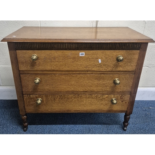 205 - AN EARLY 20TH CENTURY OAK  CHEST OF THREE LONG DRAWERS, raised on turned legs with castors, width 92... 