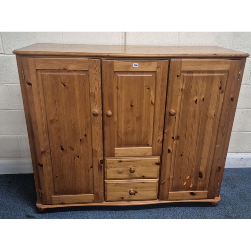 206 - A MODERN PINE LOW WARDROBE, with three cupboard doors and two drawers, raised on bun feet, width 142... 