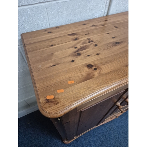 206 - A MODERN PINE LOW WARDROBE, with three cupboard doors and two drawers, raised on bun feet, width 142... 