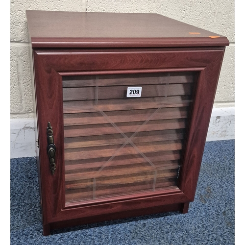 209 - A REPRODUCTION MAHOGANY EFFECT COLLECTORS CABINET, the single glass door enclosing fourteen shallow ... 