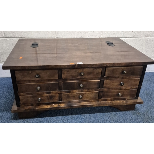 211 - A LAURA ASHLEY GARRAT DARK CHESTNUT COFFEE TABLE, with a bank of nine drawers and a hinged storage c... 