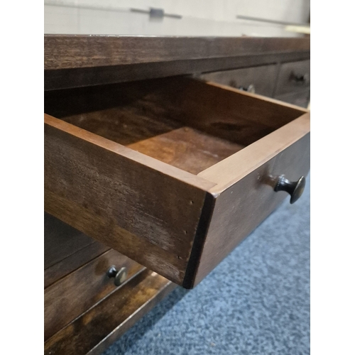 211 - A LAURA ASHLEY GARRAT DARK CHESTNUT COFFEE TABLE, with a bank of nine drawers and a hinged storage c... 