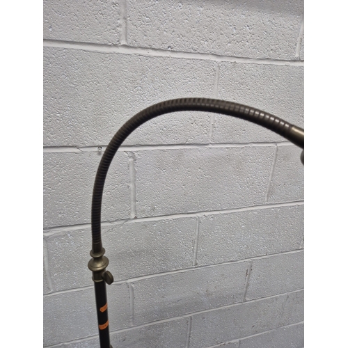 221 - LAURA ASHLEY, A BRASS STANDARD LAMP, with a cone shade and a flexible neck, on a circular stepped ba... 