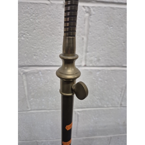 221 - LAURA ASHLEY, A BRASS STANDARD LAMP, with a cone shade and a flexible neck, on a circular stepped ba... 