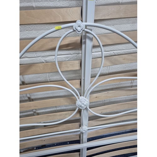 227 - A MODERN WHITE PAINTED TUBULAR METAL 4FT6 BEDSTEAD, with side rails, slats and bolts, condition repo... 