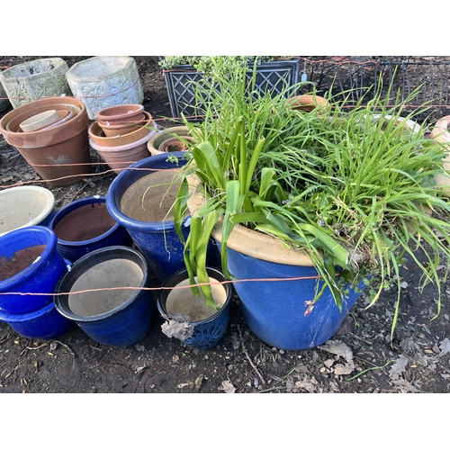 15 - TWELVE BLUE GLAZED PLANT POTS, of various shapes and sizes, the largest being 52cm high