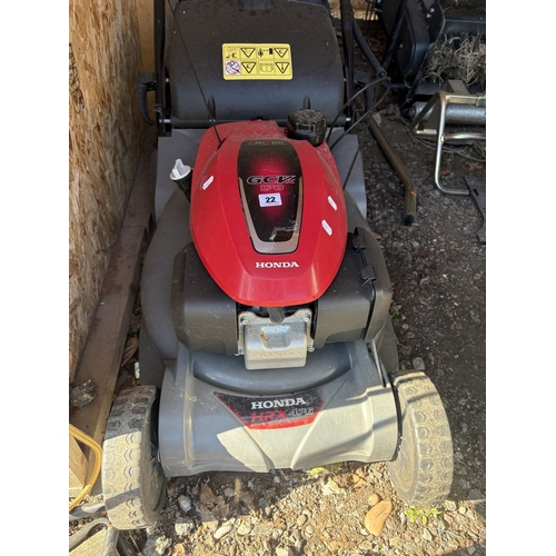 22 - A HONDA HRX 476 PETROL SELF-PROPELLED LAWNMOWER, with a grass box, condition report: engine turns fr... 