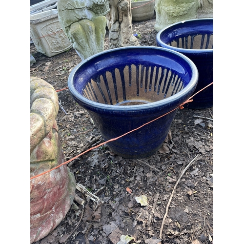 8 - FOUR PLANT POTS, including a concrete planter with lattice detail, 42cm in diameter, a pair of blue ... 