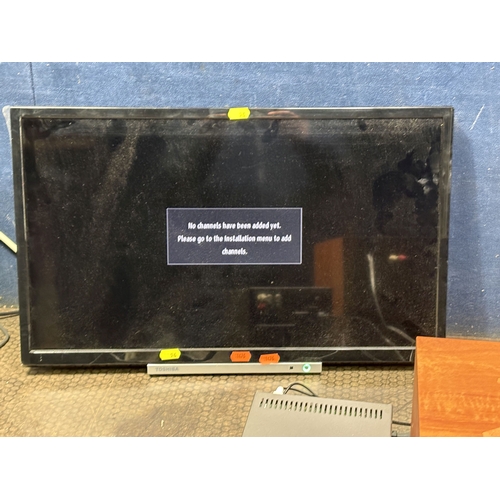 96 - A TOSHIBA 24'' LCD TV, with remote, along with a Sony hi-fi with two speakers, condition report: fau... 