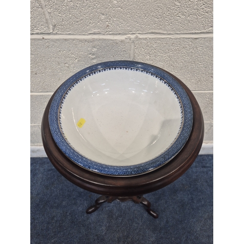 200 - A MAHOGANY WIG STAND, with a circular top, the triangle centre section with a lidded cup and two dra... 