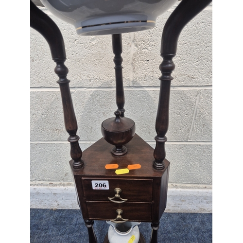 200 - A MAHOGANY WIG STAND, with a circular top, the triangle centre section with a lidded cup and two dra... 