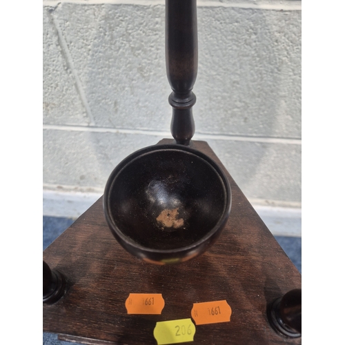 200 - A MAHOGANY WIG STAND, with a circular top, the triangle centre section with a lidded cup and two dra... 