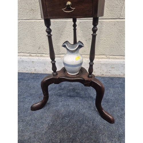 200 - A MAHOGANY WIG STAND, with a circular top, the triangle centre section with a lidded cup and two dra... 