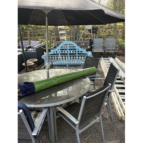 13 - A METAL AND GLASS CIRCULAR GARDEN TABLE, diameter 152cm, height 68cm, six stackable armchairs with l... 