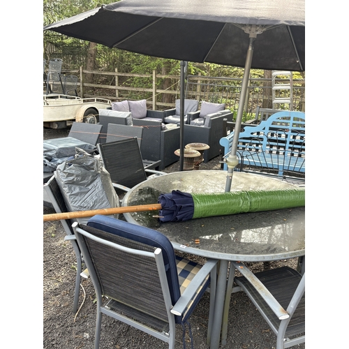 13 - A METAL AND GLASS CIRCULAR GARDEN TABLE, diameter 152cm, height 68cm, six stackable armchairs with l... 