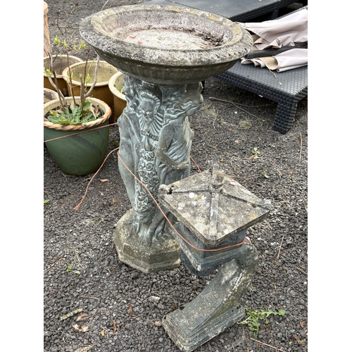 23 - A WEATHERED CONCRETE BIRD BATH, supported by three nude standing ladies and a religious figure, diam... 
