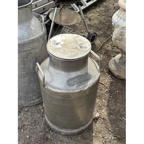 5 - TWO GALVANISED MILK CHURNS, on stamped Nestle, condition report: handle missing on one milk churn, a... 