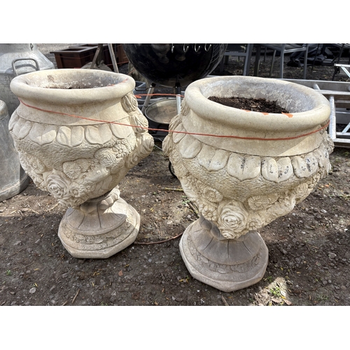 6 - A PAIR OF WEATHERED CONCRETE GARDEN URNS, decorated with roses and fruiting vines, diameter 47cm x h... 