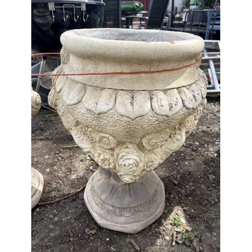 6 - A PAIR OF WEATHERED CONCRETE GARDEN URNS, decorated with roses and fruiting vines, diameter 47cm x h... 