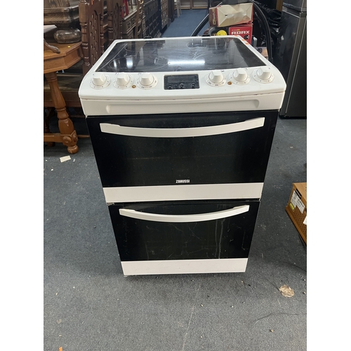 69 - A ZANUSSI ELECTRIC COOKER with a glass four-ring hob, grill and oven, width 55cm, depth 63cm, height... 