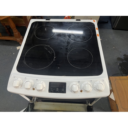 69 - A ZANUSSI ELECTRIC COOKER with a glass four-ring hob, grill and oven, width 55cm, depth 63cm, height... 