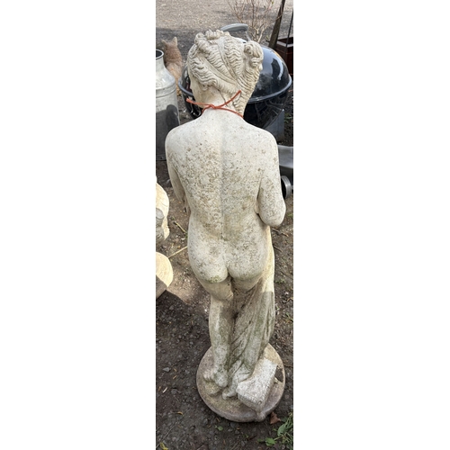 7 - A WEATHERED CONCRETE GARDEN STATUE, of a Gracian semi-clad lady, height 116cm, condition report: no ... 