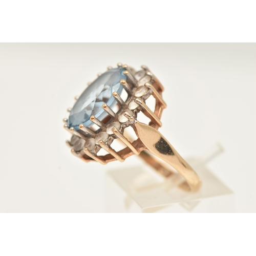 401 - A 9CT GOLD SYNTHETIC SPINEL CLUSTER RING, of an oval form, set with a central light blue oval cut st... 