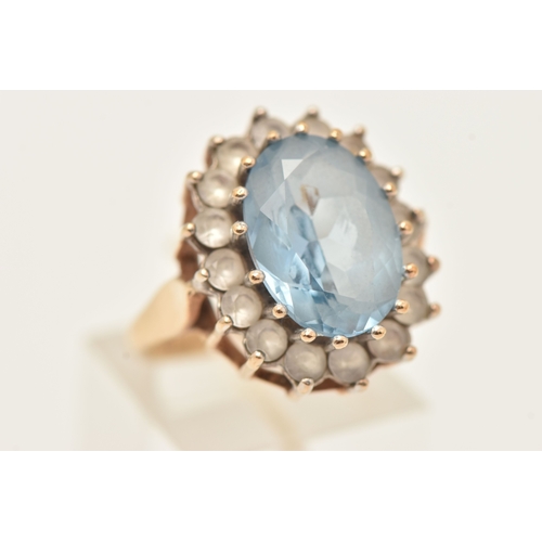 401 - A 9CT GOLD SYNTHETIC SPINEL CLUSTER RING, of an oval form, set with a central light blue oval cut st... 