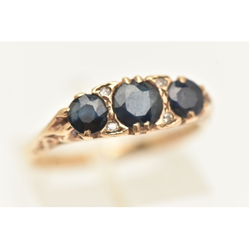 403 - A 9CT GOLD SAPPHIRE AND DIAMOND RING, set with three circular cut blue sapphires interspaced with fo... 