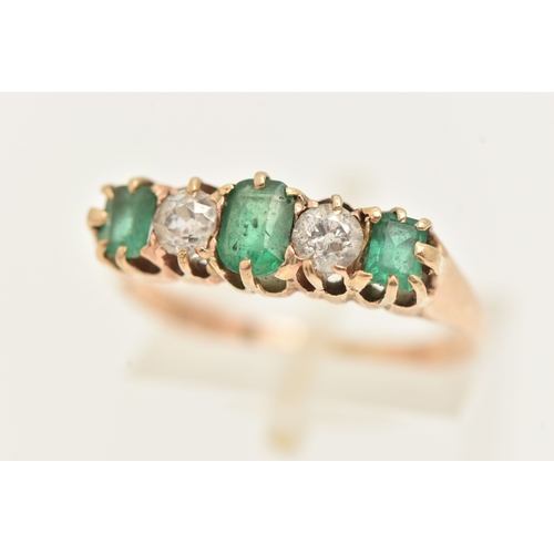 412 - A YELLOW METAL EMERALD AND DIAMOND RING, set with a central oval cut emerald, two old cut diamonds a... 