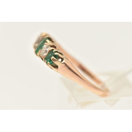 412 - A YELLOW METAL EMERALD AND DIAMOND RING, set with a central oval cut emerald, two old cut diamonds a... 
