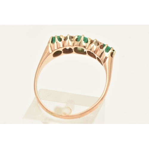 412 - A YELLOW METAL EMERALD AND DIAMOND RING, set with a central oval cut emerald, two old cut diamonds a... 