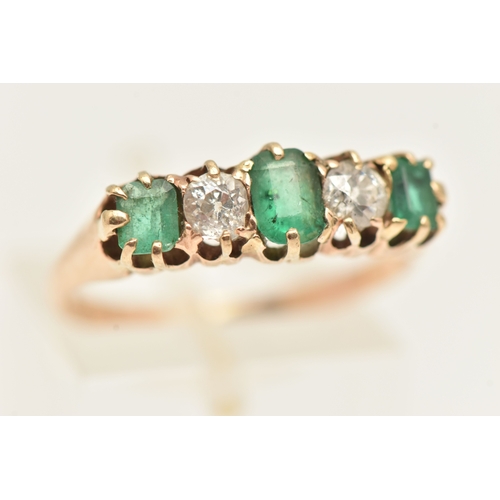 412 - A YELLOW METAL EMERALD AND DIAMOND RING, set with a central oval cut emerald, two old cut diamonds a... 
