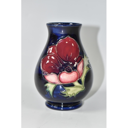 1013 - A MOORCROFT POTTERY 'ANEMONE' VASE, the small baluster vase tube lined with purple anemone flowers o... 