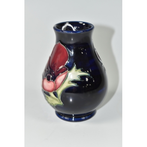 1013 - A MOORCROFT POTTERY 'ANEMONE' VASE, the small baluster vase tube lined with purple anemone flowers o... 